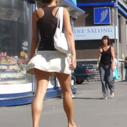 Brown-haired woman in a white mini skirt 1